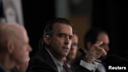 FILE - Chairman of the Federal Fiscal Control Board Jose Carrion, center, attends a meeting of the Financial Oversight and Management Board for Puerto Rico in San Juan, Puerto Rico, Oct. 31, 2017.