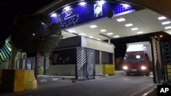 FILE - In this Nov. 6, 2019, photo by the Atomic Energy Organization of Iran, a truck containing cylinders of uranium hexafluoride gas leaves the Ahmadi Roshan uranium enrichment facility in Natanz.
