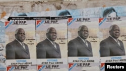 FILE - Election posters for opposition candidate Ayah Paul Abine of the People Action Party are pasted on a wall in the capital Yaounde, Cameroon, Oct. 7, 2011. 