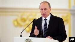 FILE - Russian President Vladimir Putin gives a speech during an awards ceremony for Russia's Olympians in Moscow's Kremlin in Moscow, Russia, Aug. 25, 2016. 