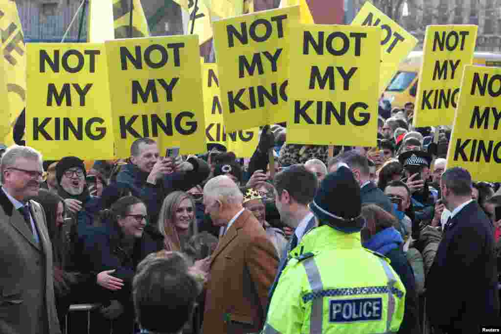 Britain's King Charles interacts with well-wishers as anti-monarchy demonstrators display, "Not my king", posters, during a visit to Middlesbrough.