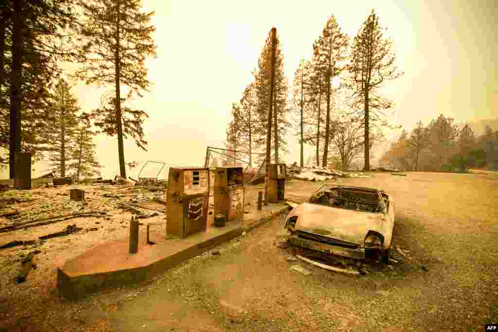 A burnt car and a gas station remain visible after the "Camp" fire tore through the region near Pulga, east of Paradise, California