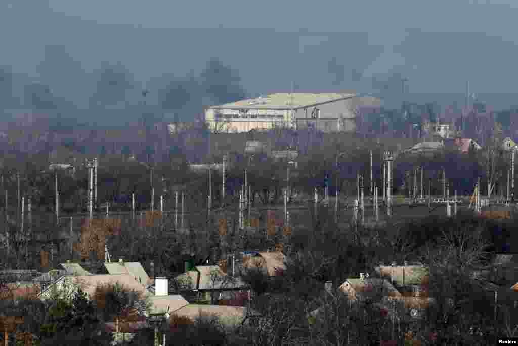 Smoke rises above a hangar at the Sergey Prokofiev International Airport after fighting between pro-Russian separatists and Ukrainian government forces in Donetsk, eastern Ukraine, Nov. 9, 2014.