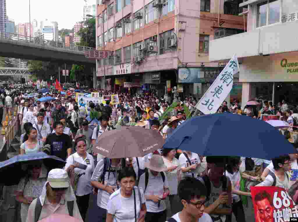 今天是香港回归17周年纪念日,在官方和亲北京团体举行各种庆祝活动的同时,几十万市民下午冒着高温走上街头,参加七一大游行(美国之音海彦拍摄)