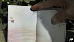 A Chinese passport where the top left corner shows a territorial map of China that includes disputed South China Sea islands, Nov. 23, 2012. 