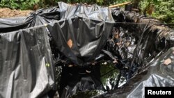 Una piscina improvisada de crudo robado de un oleoducto cercano por grupos ilegales para la producción de un combustible artesanal llamado "Pategrillo", utilizado para la producción de cocaína, en Tumaco, Colombia, el 8 de septiembre de 2022. REUTERS/Luisa González
