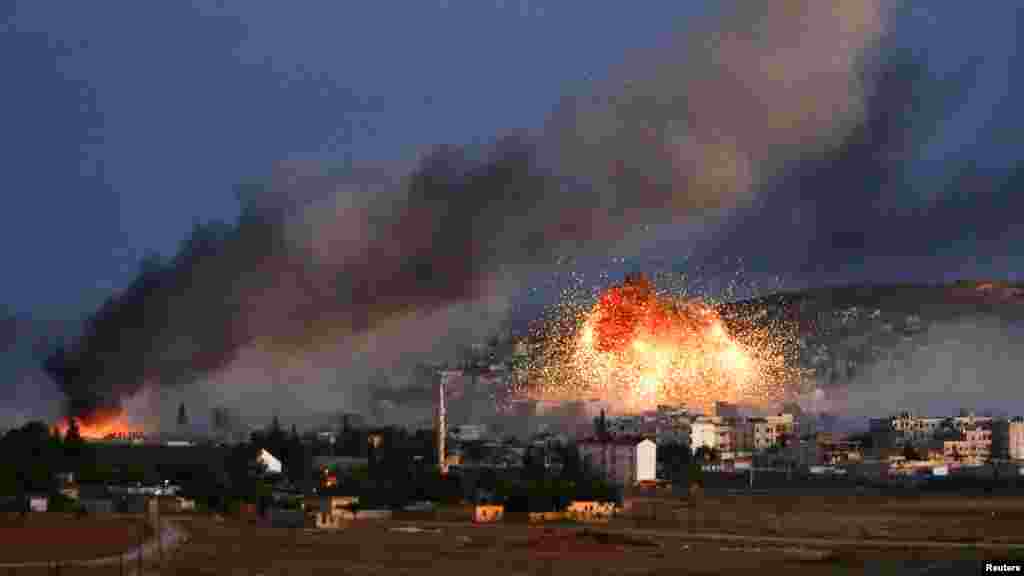 Smoke and flames rise over Syrian town of Kobani after an airstrike, as seen from the Mursitpinar crossing on the Turkish-Syrian border in the southeastern town of Suruc, Sanliurfa province, Oct. 20, 2014.