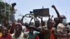FILE - People celebrate as the Guinean Special Forces arrive at the Palace of the People in Conakry, Sept. 6, 2021.