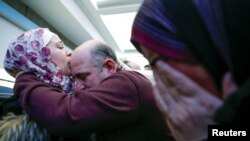 Penaberê Sûrî Baraa Haj Khalaf babê xwe maç dike û diya wê digirî dema gihane firokxana Chicago, Illinois - Amerîka
