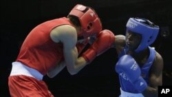 Kenya's Benson Njangiru fights Egypt's Hesham Abdelaal, left, in boxing match at 2012 Summer Olympics July 30, 2012.