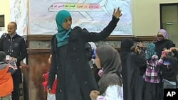 Hafsa Abdelrahman leads the children of the Dar Al-Hijrah weekend school in Falls Church, Virginia, into a mock-up of the Muslim holy city Mecca, October 2011.