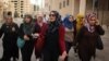 Maysoun Qawasmi and her supporters walk through a town in the West Bank ahead of the Palestinian elections. (VOA / R. Collard)
