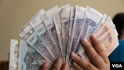 FILE - Different banknotes of Cambodian Khmer Riel are displayed at a local currency exchange store in Phnom Penh, October 13, 2020. (Malis Tum/VOA Khmer)