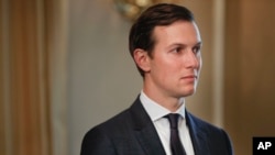 FILE - White House senior adviser Jared Kushner listens as President Donald Trump answers reporters' questions at Trump National Golf Club in Bedminster, N.J., Aug. 11, 2017.