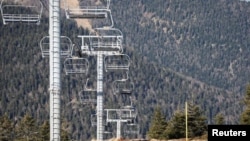In this file photo, chairlifts are pictured over ski slopes closed due to lack of snow, at the ski resort of The Mourtis in Boutx, France, February 10, 2020. (REUTERS/Regis Duvignau)