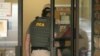 FILE - A Drug Enforcement Administration officer walks into a medical clinic in Little Rock, Arkansas, May 20, 2015.