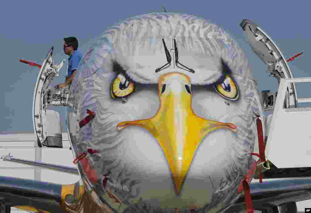 A man looks out of the door of a Embraer E195-E2 prototype, developed by Brazilian aerospace company Embraer, at Paris Air Show, on the eve of its opening, in Le Bourget, east of Paris, France.