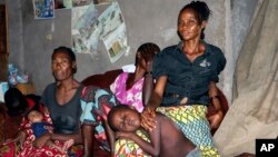 Family and friends comfort Irene Mboyo Mola, 30, whose husband died in May from Ebola and whose six children have been vaccinated but she refused, saying she doesn't believe he died from the disease, in her house in the town of Mbandaka, Congo, June 1, 2018.