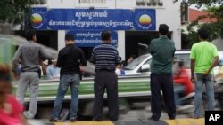FILE PHOTO - Journalists wait in front of Cambodia National Rescue Party (CNRP) headquarters during the party's meeting, in Phnom Penh, Cambodia, Thursday, May 26, 2016. (AP Photo/Heng Sinith)