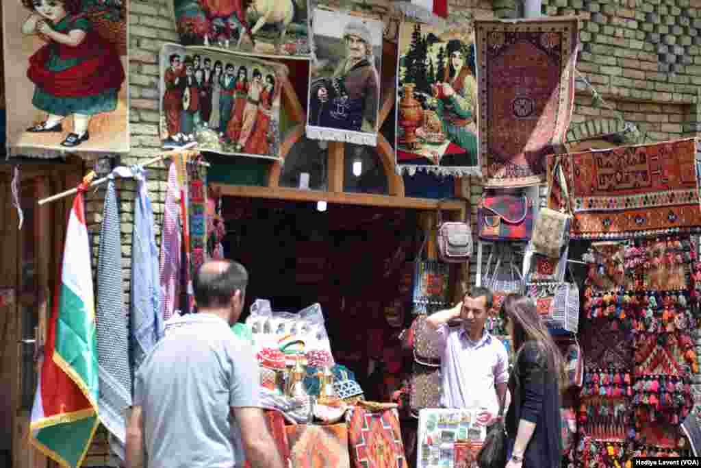 A store in the souq sells traditional patterned fabrics and portraits of important people, in Irbil, Iraq. 