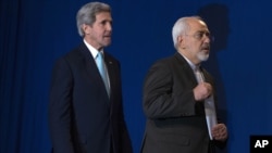 File- U.S. Secretary of State John Kerry, left, and Iranian Foreign Minister Javad Zarif arrive to deliver a statement, at the Swiss Federal Institute of Technology in Lausanne, Switzerland, April 2015.