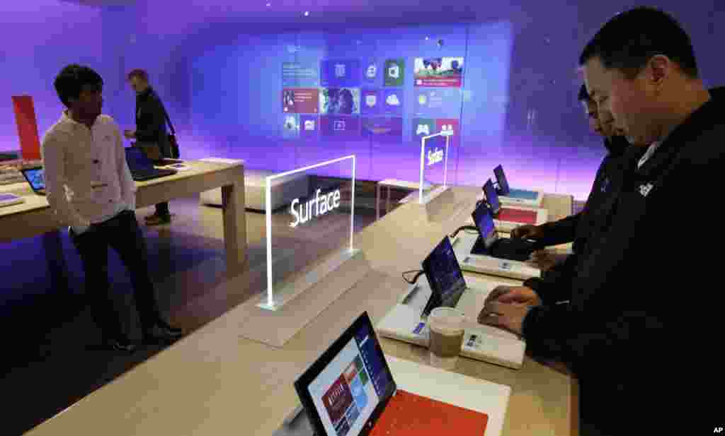Visitors try out Microsoft Corp.'s "Surface" touchscreen tablet computers, Oct. 31, 2012, at "Build," Microsoft Corp.'s developers conference, in Redmond, Washington.
