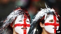 Two young England football supporters, their faces painted with the St George's Cross, at a World Cup qualifying match in London in 2009