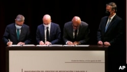 El delegado opositor Gerardo Blyde, el diplomático noruego Dan Nylander, el delegado oficialista Jorge Rodríguez firman el memorando de entendimiento del diálogo sobre Venezuela en Ciudad de México, el 13 de agosto de 2021. Los observa el canciller mexicano Marcelo Ebrard.