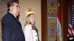 U.S. Secretary of State Hillary Clinton, right, walks alongside Tajikistan's President Emomali Rakhmon at the Palace of the Nation in Dushanbe, Tajikistan, Oct. 22, 2011.