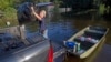 Daniel Stover, 17, loads personal belongings from a friend's home flooded home in Sorrento, La., Aug. 20, 2016. 
