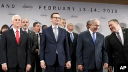 FILE - U.S. Vice President Mike Pence, PM of Poland Mateusz Morawiecki, Israeli PM Benjamin Netanyahu and U.S. Secretary of State Mike Pompeo, from left, stand on a podium at a conference on Peace and Security in the Middle East in Warsaw, Poland.