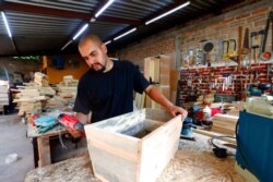 Jesus Lopez works in his family's carpentry workshop in Zapopan, Jalisco state, Mexico, May 13, 2021. Lopez arrived in the U.S. when he was 9 on a tourist visa that later expired. He became a Deferred Action for Childhood Arrivals recipient in 2012.