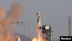 FILE - Blue Origin's New Shepard rocket lifts off in west Texas, Dec. 11, 2021. Blue Origin and two rivals are the first to be selected in a competition among U.S. rocket companies vying to launch military and intelligence satellites into space for roughly the next decade. 