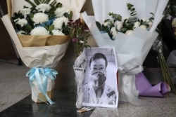 FILE - A makeshift memorial for Li Wenliang, a doctor who issued an early warning about the coronavirus outbreak before it was officially recognized, is seen after Li died of the virus, at Central Hospital of Wuhan, China, Feb. 7, 2020.