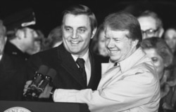FILE - President Jimmy Carter embraces Vice President Walter Mondale on the South Lawn of the White House in Washington on Jan. 7, 1978.