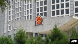 FILE - China's national emblem is seen on the Ministry of Foreign Affairs building in Beijing, July 26, 2023.