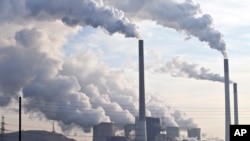 FILE - Steam and smoke is seen over the coal burning power plant in Gelsenkirchen, Germany.