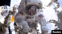 NASA astronaut Peggy Whitson is seen during a spacewalk outside the International Space Station. Whitson is to return to Earth Saturday as the American astronaut with the most time in space, 665 days.