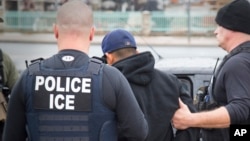 In this Feb. 7, 2017, photo released by U.S. Immigration and Customs Enforcement shows foreign nationals being arrested during an operation conducted by U.S. Immigration and Customs Enforcement (ICE) aimed at immigration fugitives, re-entrants and at-lar