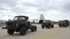FILE - Military vehicles and equipment, parts of the S-400 air defense systems, are seen on the tarmac, after they were unloaded from a Russian transport aircraft, at Murted military airport in Ankara, July 12, 2019.