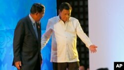 Philippine President Rodrigo Duterte, right, ushers Cambodian Prime Minister Hun Sen following the opening ceremony for the ongoing 28th and 29th ASEAN Summits and other related summits Tuesday, Sept. 6, 2016 in Vientiane, Laos. (AP Photo/Bullit Marquez)