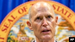 Florida Governor Rick Scott lays out his school safety proposal during a press conference at the Florida Capitol in Tallahassee, Fla., Feb. 23, 2018. Scott proposed banning the sale of firearms to anyone younger than 21 as part of a plan to prevent gun violence. 
