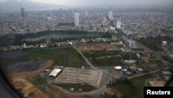 FILE - The cleaning operation of the area that was used for storing Agent Orange is seen from a plane taking off from Danang international airport.