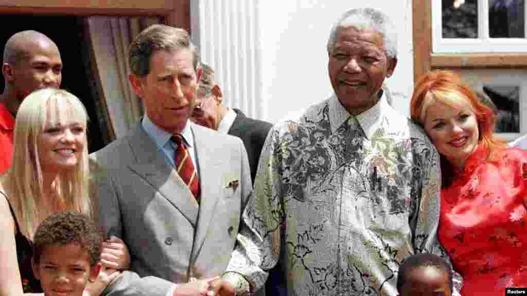 President Nelson Mandela and Britain's Prince Charles shake hands alongside members of the Spice Girls' Emma (L), and Gerri (R) at Mr. Mandela's residence November 1, 1997.