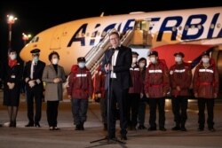 Serbian President Aleksandar Vucic talks in front of medical experts from China after they arrived with medical supplies to help country's fight against coronavirus (COVID-19) outbrake in Belgrade, Serbia, March 21, 2020.