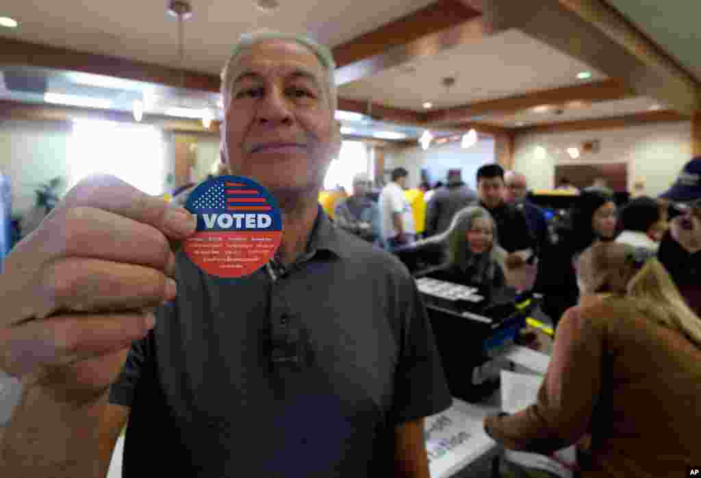 Frank Salazar, 70, shows an 'I voted' sticker after casting his ballot on the Super Tuesday, at a voting center in Alhambra, Calif., March 3, 2020.