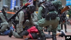 FILE - Riot police detain a protester during a demonstration against Beijing's national security legislation in Causeway Bay in Hong Kong on May 24, 2020. Hong Kong began work on a local National Security Law on Jan. 30, 2024.