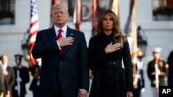 Presiden AS Donald Trump dan ibu negara Melania Trump mengheningkan cipta bagi para korban serangan 11 September 2001, dalam acara peringatan di Gedung Putih, Senin (11/9). 