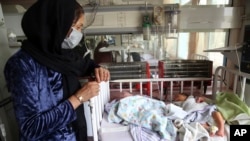 Babies lie in their beds at the Ataturk Children's Hospital a day after they were rescued following a deadly attack on another maternity hospital, in Kabul, Afghanistan, May 13, 2020. 