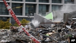 Smoke rises from the collapsed CTV building, that housed a TV broadcaster and an English language school, following Tuesday's earthquake Christchurch, New Zealand, February 23, 2011.